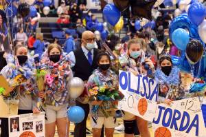 Thunder Mountain High School seniors (from left to right) Grace Sikes, Sydney Strong, Jo Pasion, Olissa Oliver and Jorda Basiliso stand with coach Andy Lee (center) before Saturdays senior night game against Ketchikan. (Ben Hohenstatt / Juneau Empire)