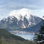 A sudden break in the cloud cover highlights the top of snow-capped Mount Juneau. (Courtesy Photo / Denise Carroll)
