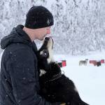 Five-time Iditarod champion Dallas Seavey is shown Feb. 22, 2022, playing with Ace, one of his dogs at his kennel in Talkeetna, Alaska. Seavey is tied with musher Rick Swenson for the most Iditarod victories ever, and Seavey is looking for his sixth title when the Iditarod Trail Sled Dog Race starts Saturday, March 5, in Alaska. (AP Photo / Mark Thiessen)