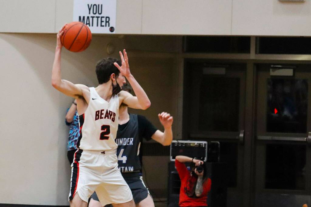 JDHS' Tias Carney prepares to pass the ball as they play TMHS on March 5, 2022. (Michael S. Lockett / Juneau Empire)
