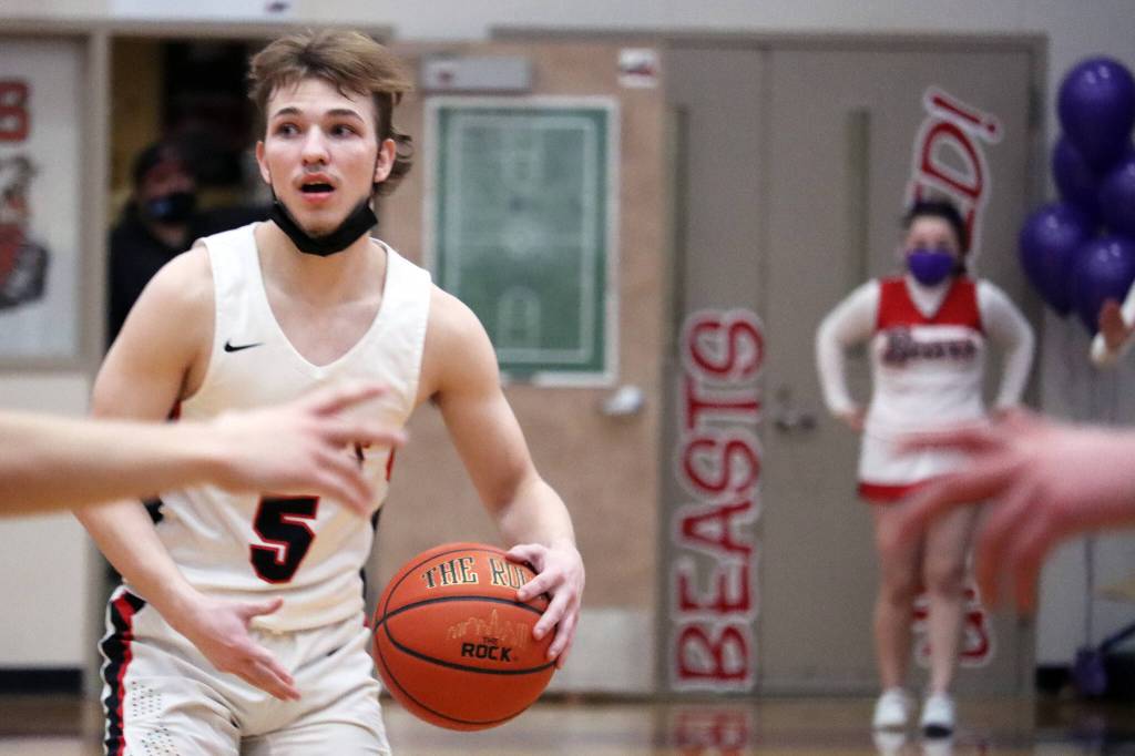 Ben Hohenstatt / Juneau Empire
Chris Harris, a junior, surveys the court as defenders on either side try to block off passing lanes on Friday night. Harris scored 6 points for the Crimson Bears.
