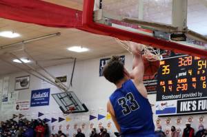 Thomas Baxter throws down a dunk to score two of his game-high 29 points on Friday night at Juneau-Douglas High School: Yadaa.at Kalé. (Ben Hohenstatt / Juneau Empire)