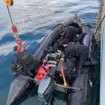 Royal Canadian Navy divers load tanks onto a boat as they prepare to go investigate a simulated naval mine in Stephens Passage on March 6, 2022 as part of exercise Arctic Edge 2022. (Michael S. Lockett / Juneau Empire)