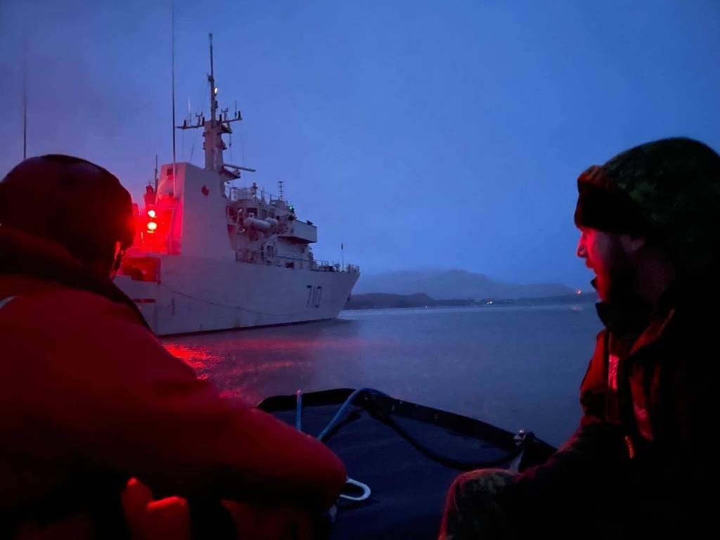 Sailor 3rd Class Travis Coleman, left, and Cpl. Hugo Montpetit look at Her Majestys Canadian Ship Brandon as they prepare to go aboard on March 6, 2022 as part of exercise Arctic Edge 2022. (Michael S. Lockett / Juneau Empire)