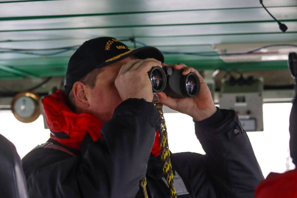 Lt. Cmdr. Mike Wills, captain of Her Majestys Canadian Ship Brandon, a minesweeping vessel, looks at a small boat deployed from the ship in the Stephens Passage on March 6, 2022 as part of exercise Arctic Edge 2022. (Michael S. Lockett / Juneau Empire)