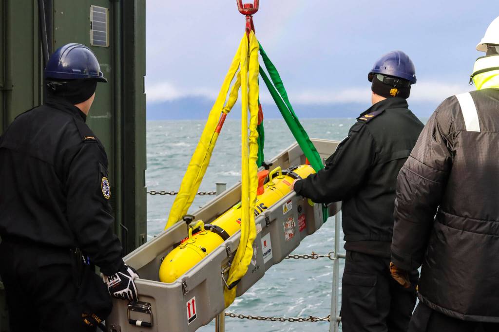 Royal Canadian Navy sailors load the remote environmental monitoring units unmanned underwater vehicle onto a small boat in Stephens Passage on March 6, 2022, as part of exercise Arctic Edge 2022. (Michael S. Lockett / Juneau Empire)