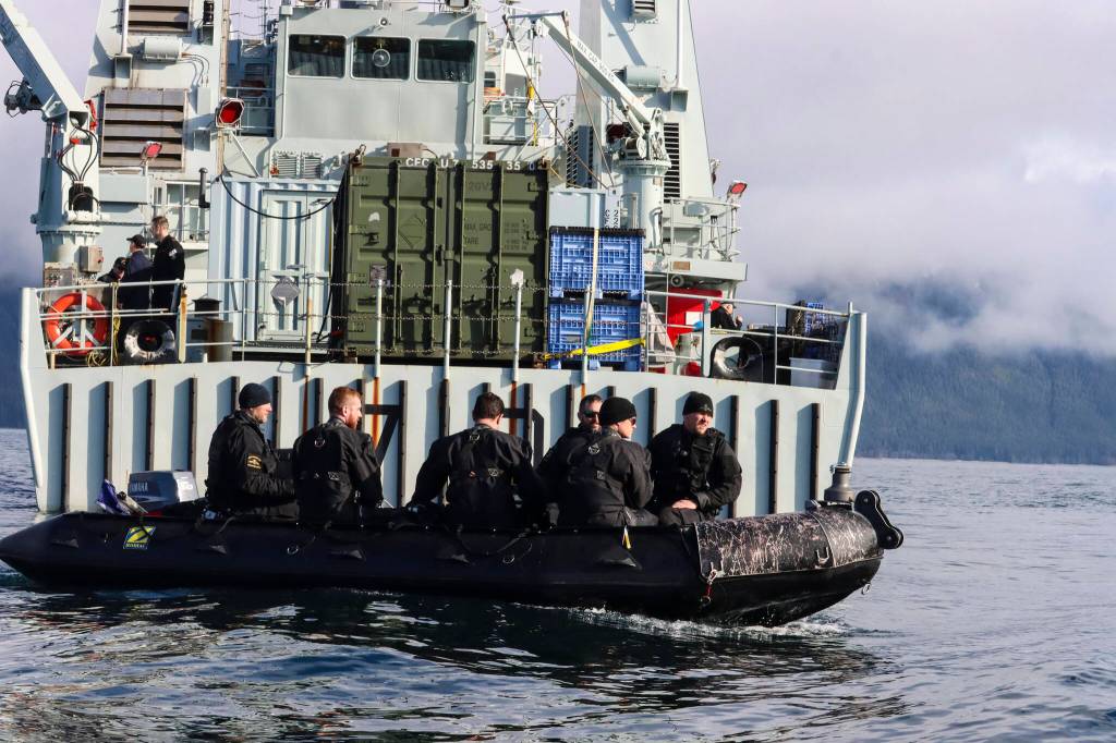 Royal Canadian Navy divers navigate aft of Her Majestys Canadian Ship Brandon to go investigate a simulated naval mine in Stephens Passage on March 6, 2022, as part of exercise Arctic Edge 2022. (Michael S. Lockett / Juneau Empire)