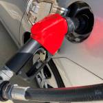 A car is shown at a gas pump, Friday, Jan. 21, 2022, at a gas station in North Miami, Fla. Gov. Mike Dunleavy and Alaska state lawmakers are moving to temporarily suspend the state's motor fuel tax as oil prices rise. (AP Photo/Wilfredo Lee)