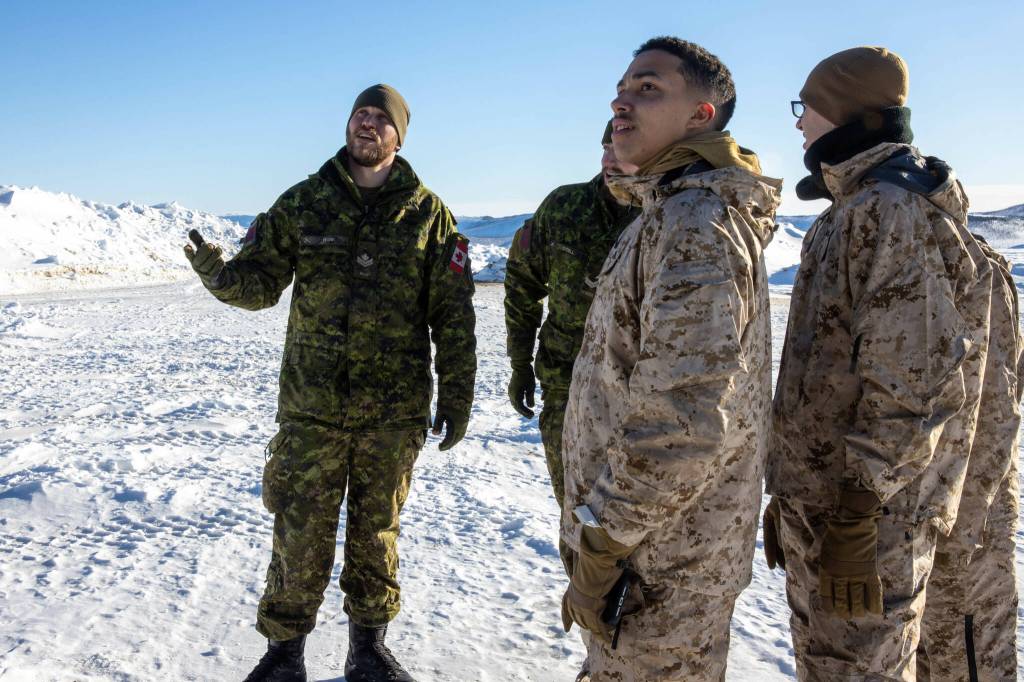 Canadian Army Master Bombardier Ian Frank, a radar detachment commander with 128 Battery, 4th Artillery Regiment, explains his units operations in Exercise Arctic Edge 2022, to U.S. Marine Corps food specialists, with 2nd Landing Support Battalion, on Eielson Air Force Base, Alaska, March 15, 2022. (U.S. Marine Corps / Lance Cpl. Jessica J. Mazzamuto)