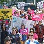This May 21, 2019, photo shows people attending a rally against anti-abortion laws at the Dimond Courthouse Plaza in Juneau, Alaska. Alaska voters this year will be asked if they want a constitutional convention, and simmering anger over the legislatures failure to settle the issue of how big a check residents should receive from the states oil wealth fund could provide a tail wind for groups seeking to change the constitution on a range of hot button topics, such as abortion. (Michael Penn/ Juneau Empire File)
