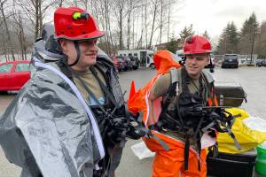 National Guardsmen Sgt. Andrew Hunt and Sgt. Jason Williams, survey team members for the 103rd Civil Support Team, suit up as they prepare to investigate a simulated hazardous material situation in an exercise with Juneaus emergency organizations on march 22, 2022. (Michael S. Lockett / Juneau Empire)
