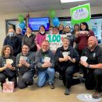 Courtesy Photo 
Juneau Animal Rescue staff and members of 100+ Women Who Care Juneau pose for a photo with the multitude of checks received from the 100+ Women Who Care Juneau.