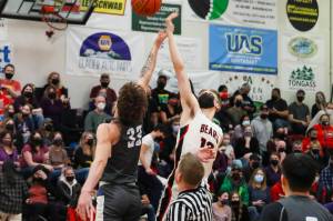 JDHS Jake Sleppy, right, vies for the ball in a tipoff against TMHS during the regular basketball season. JDHS just ended their season with an unsuccessful championship attempt. (Michael S. Lockett / Juneau Empire File)