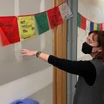 Michael S. Lockett / Juneau Empire 
Riverbend Elementary School principal Elizabeth Pisel-Davis gestures at drawings of things schoolchildren were thankful for that currently decorate the walls of the school after massive flooding from a burst pipe in January meant much the schools interior had to be gutted.