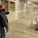 Michael S. Lockett / Juneau Empire 
Riverbend Elementary School principal Elizabeth Pisel-Davis gestures at the walls and concrete floors left bare following massive flooding from a burst pipe in the school in January.