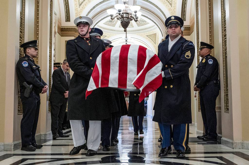 An honor guard carries the flag-draped casket of former Rep. Don Young, R-Alaska, into the U.S. Capitol where he will lie in state in Washington, Tuesday, March 29, 2022. (Jim Watson/Pool Photo via AP)