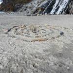 A spiral of stones lies in front of Nugget Falls. (Courtesy Photo / Shammy Perdon)