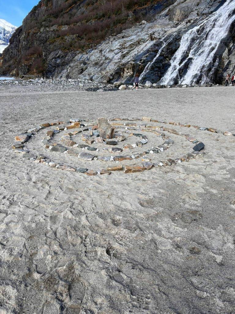 A spiral of stones lies in front of Nugget Falls. (Courtesy Photo / Shammy Perdon)