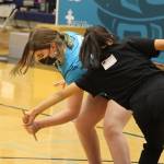 Layla Harrison, 12, of Chickaloon and Dawnielle Patterson, 14, of Bethel compete in the Denè stick pull during the 2022 Traditional Games. Harrison placed third and Patterson placed fifth in the event for their age group. (Ben Hohenstatt / Juneau Empire)