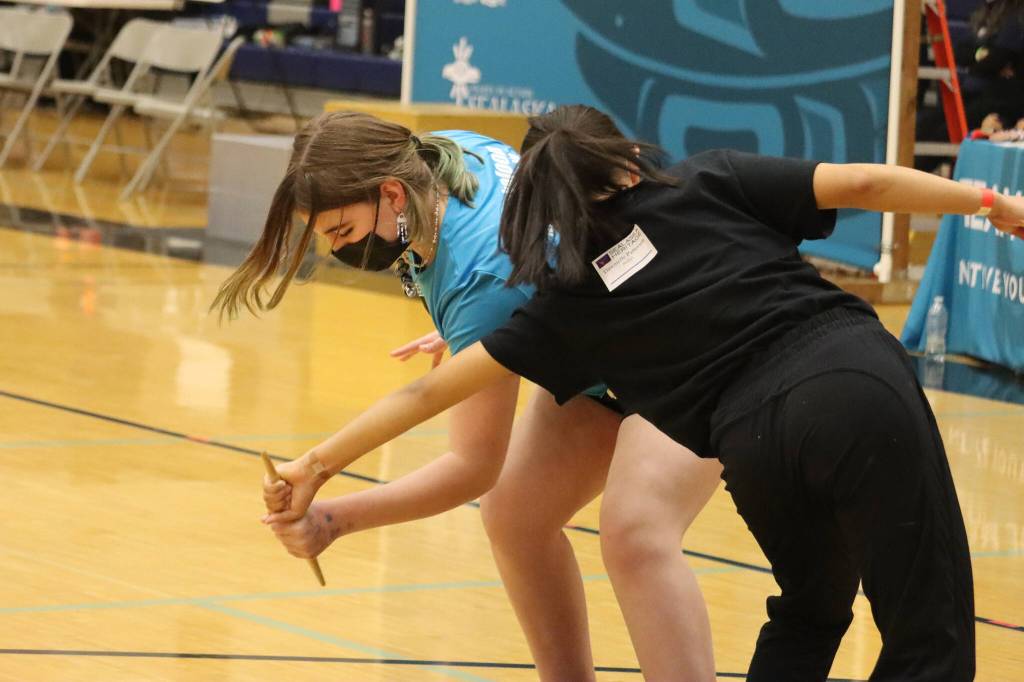 Layla Harrison, 12, of Chickaloon and Dawnielle Patterson, 14, of Bethel compete in the Denè stick pull during the 2022 Traditional Games. Harrison placed third and Patterson placed fifth in the event for their age group. (Ben Hohenstatt / Juneau Empire)