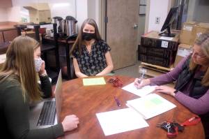 Paula Casperson (center) meets Wednesday at JDHS with Amanda Duvall (left) the district’s teacher and learning support coordinator, and Carrie Pusich, an activities assistant for the district. (Mark Sabbatini / Juneau Empire)