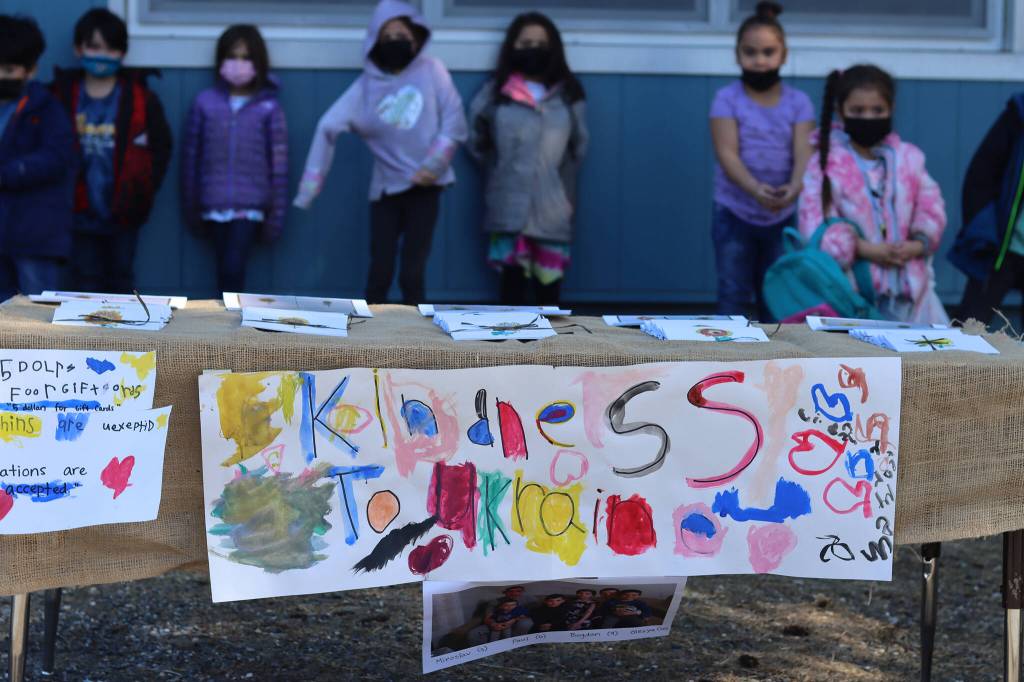 A sign reading Kindness to Ukraine marks a place for community members to buy cards to support a displaced Ukrainian family living in Washington state. Friday, Students in Carly Lehnharts kindergarten class sold cards decorated with pictures of sunflowers, Ukraines national flower, to raise money for the family. (Ben Hohenstatt / Juneau Empire)