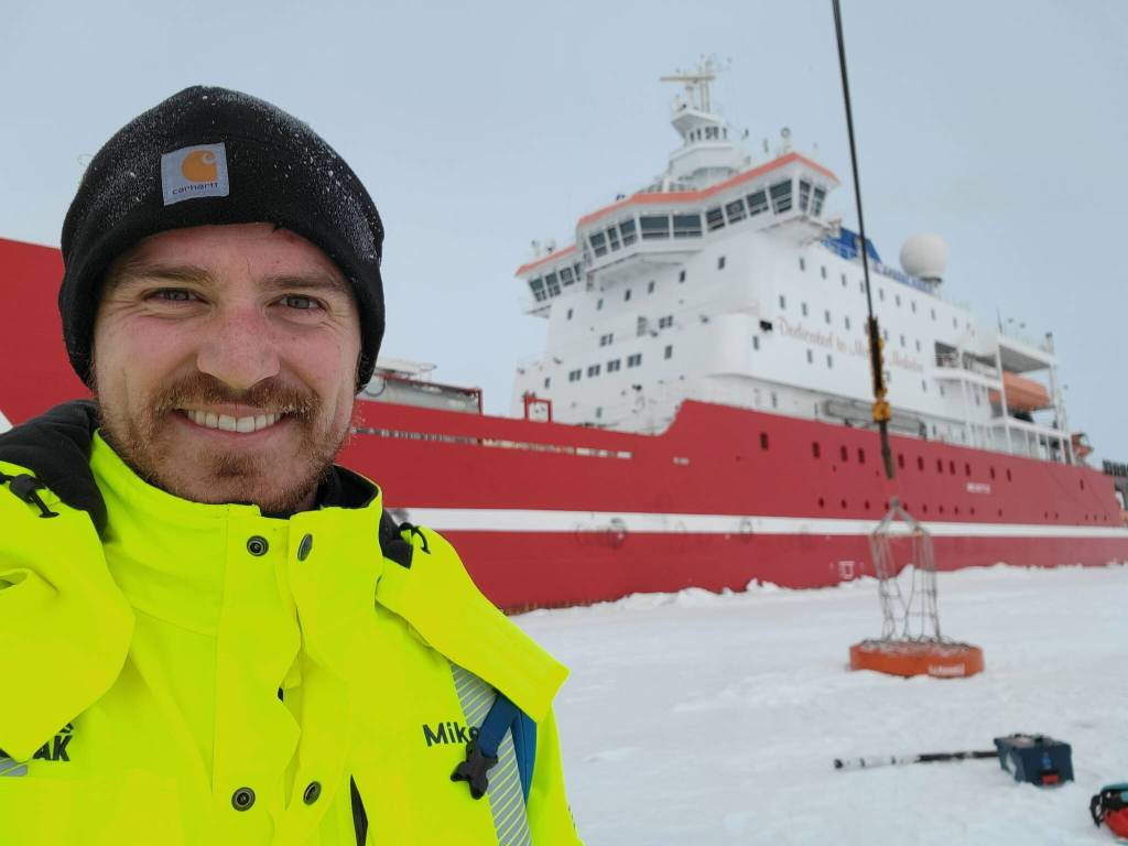 Michael Patz, raised in Juneau and part of the expedition to find the wreck of Ernest Shackletons vessel, the Endurance, stands in front of the S.A. Agulhas II, the expeditions icebreaker. (Courtesy photo / Michael Patz)