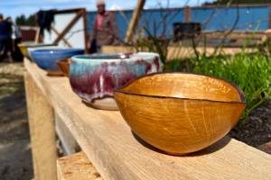 Some of the bowls available for selection by attendees of the Empty Bowls event, the Glory Halls annual fundraiser, sit on display at the shelters new garden. (Michael S. Lockett / Juneau Empire)