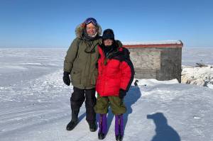 George Divoky and his friend Matt Thomas pose in front of Divoky’s cabin on Cooper Island after repairing polar-bear damage in April, 2022. (Courtesy Photo / Craig George)