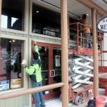 Kyle Brownlee, left, and Joseph Cox of Island Contractors paint the storefront of Red Dog Mercantile on Friday as downtown merchants get ready to welcome the first cruise ship of the year on Monday. (Mark Sabbatini / Juneau Empire)