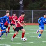 JDHS player Gabe Cheng drives down the field with the ball during a tight game against TMHS on April 23, 2022. (Michael S. Lockett / Juneau Empire)
