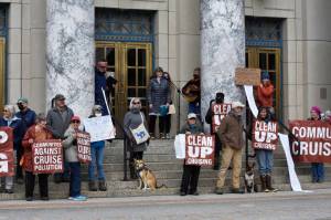 Protestors critical of the cruise ship industry gathered on the steps of the Alaska State Capitol on Monday, April 25, 2022, the same day the first large ship of the season arrived in Juneau. Demonstrators said the industry had a poor environmental record and called on the state to continue to Ocean Rangers program, a voter-approved initiative which put state monitors aboard ships to ensure compliance with state regualtions. (Peter Segall / Juneau Empire)