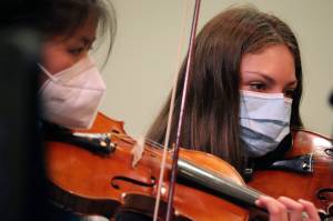 Jin Yue Trousil, left, and Angela Huffer practice for the upcoming Juneau Symphony concert this weekend beginning April 30. (Ben Hohenstatt / Juneau Empire)