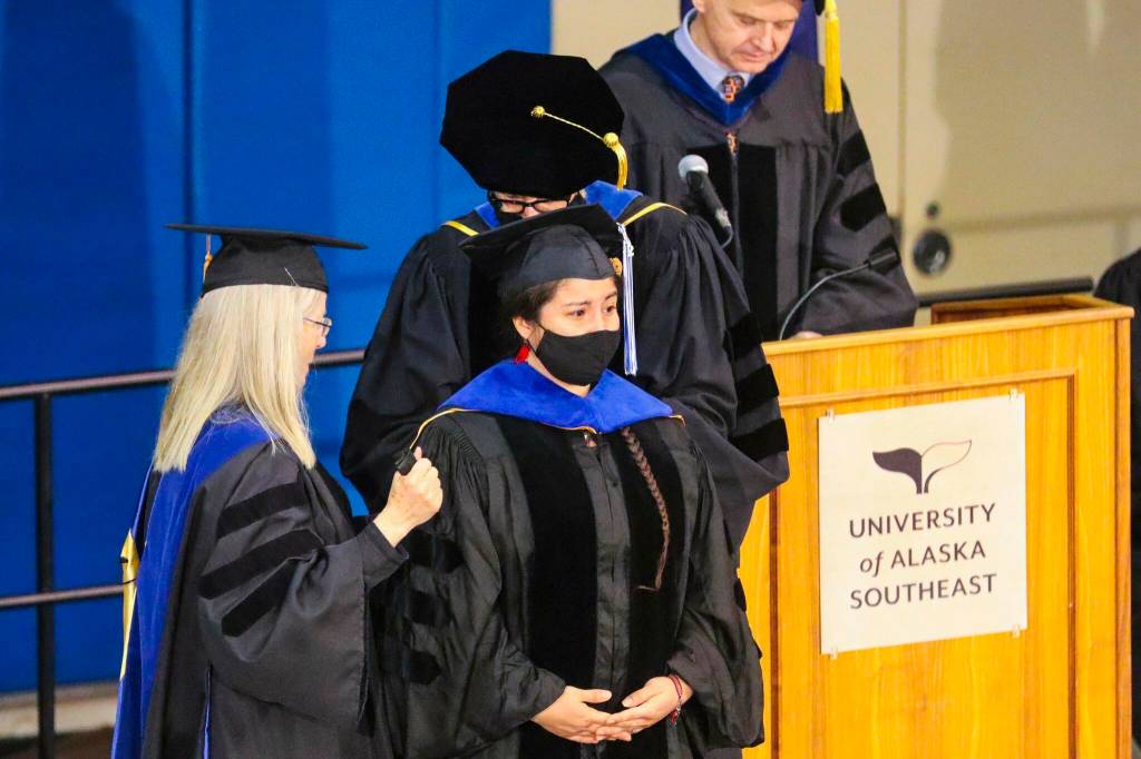 Sonia Ibarra stands as she receives her Ph.D in fisheries during the commencement ceremony for University of Alaska Southeast on May 1, 2022. (Michael S. Lockett / Juneau Empire)