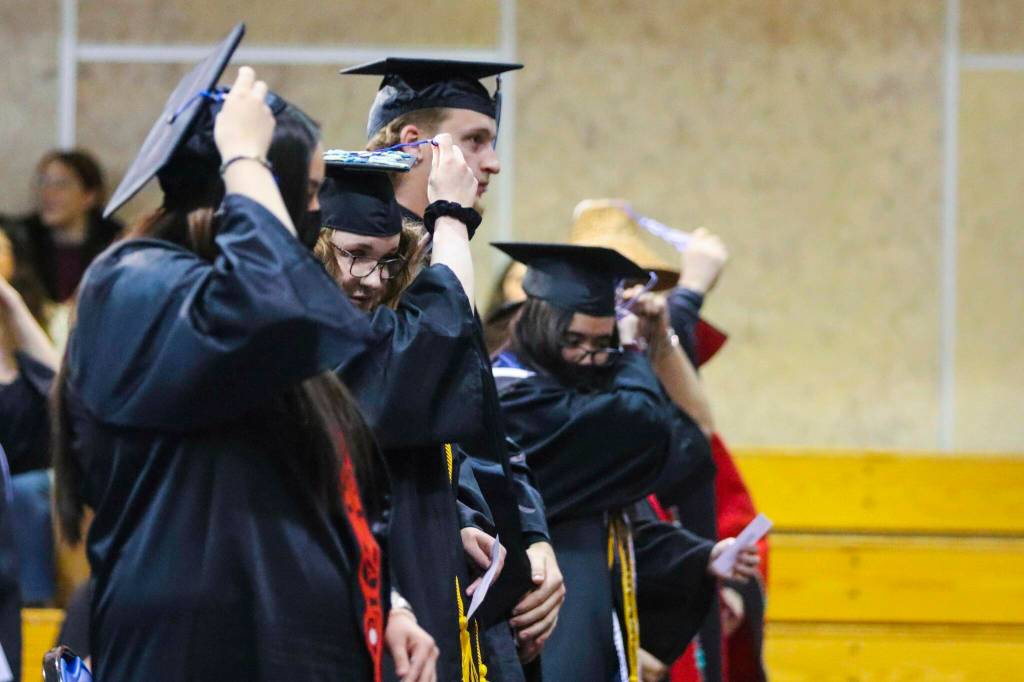 Students switch their tassels to signify their status as graduates at the commencement ceremony for University of Alaska Southeast on May 1, 2022. (Michael S. Lockett / Juneau Empire)