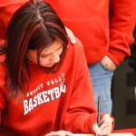 JDHS basketball player Trinity Jackson signs her letter of intent to play basketball for Skagit Valley College on May 4, 2022. (Michael S. Lockett / Juneau Empire)