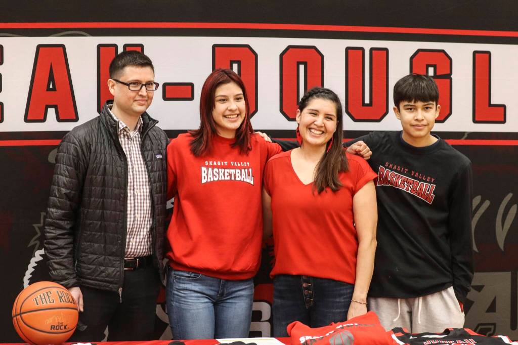 JDHS basketball player Trinity Jackson stands with friends and family after signing her letter of intent to play basketball for Skagit Valley College on May 4, 2022. (Michael S. Lockett / Juneau Empire)