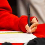 JDHS basketball player Trinity Jackson signs her letter of intent to play basketball for Skagit Valley College on May 4, 2022. (Michael S. Lockett / Juneau Empire)