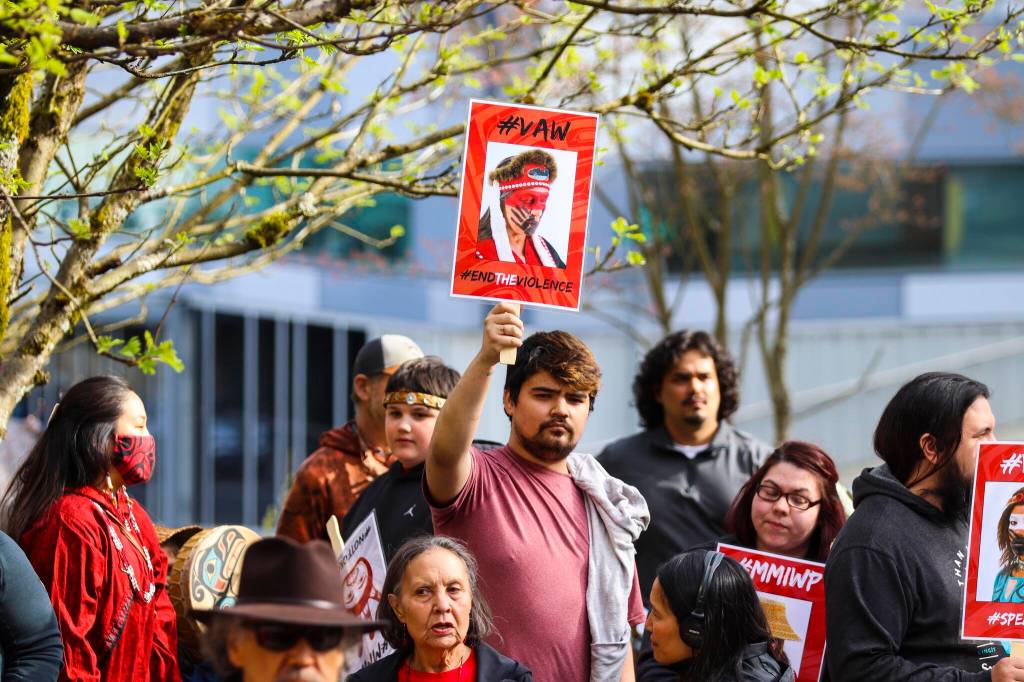 Rally-goers hold up signs before the annual Missing and Murdered Indigenous Persons rally at the Alaska State Capitol on May 5, 2022. (Michael S. Lockett / Juneau Empire)