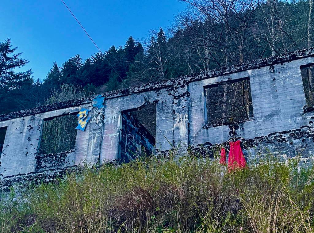 A small and medium sized dress symbolizing a murdered or missing child and teenage girl respectively hang from the ruins of off Gastineau Avenue following the annual Murder and Missing Indigenous Persons rally on May 5, 2022. (Michael S. Lockett / Juneau Empire)