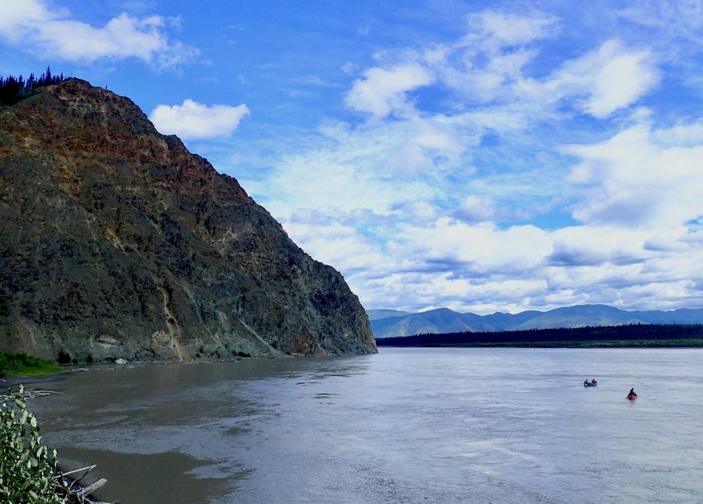 Two canoes float past Eagle, Alaska, in July, 2018. (Courtesy Photo / Ned Rozell)