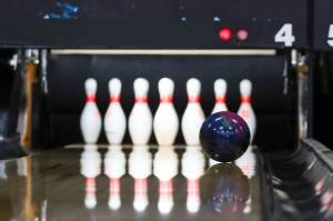 A ball streaks down the lane at an unbroken formation of pins at Pinz, Juneaus bowling alley, on May 5, 2022. (Michael S. Lockett / Juneau Empire)