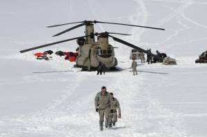 Capt. Corey Wheeler, front, commander of B Company, 1st Battalion, 52nd Aviation Regiment at Fort Wainwright, Alaska, walks away from a Chinook helicopter that landed on the glacier near Denali, April 24, 2016, on the Kahiltna Glacier in Alaska. The U.S. Army helped set up base camp on North America's tallest mountain. The U.S. Army is poised to revamp its forces in Alaska to better prepare for future cold-weather conflicts, and it is expected to replace the larger, heavily equipped Stryker Brigade there with a more mobile, infantry unit better suited for the frigid fight, according to Army leaders. (AP Photo/Mark Thiessen, File)