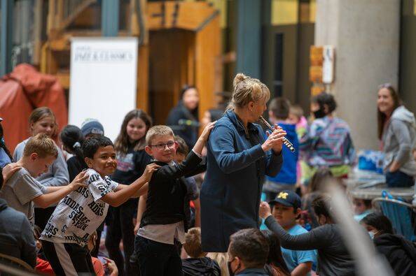 Canadian sax/flute player Jane Bunnett leads a procession of students through the State Office Building during a lunchtime concert Friday. (Courtesy Photo)