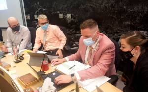 Juneau City Finance Director Jeff Rogers, second from right, updates next year’s city budget to reflect changes made Wednesday night by the Assembly’s Finance Committee during a break in the meeting. The committee approved a $172.3 million general fund spending plan that on paper shows a $10.3 million surplus, but that extra amount is subject to considerable unpredictability – including a potential loss of $16 million in state funds – before a final budget is approved by the full Assembly by June 15. Assisting Rogers with the budget presentation to Assembly members are, from left, Deputy City Manager Robert Barr, City Manager Rorie Watt and Budget Analyst Adrien Speegle. (Mark Sabbatini / Juneau Empire)