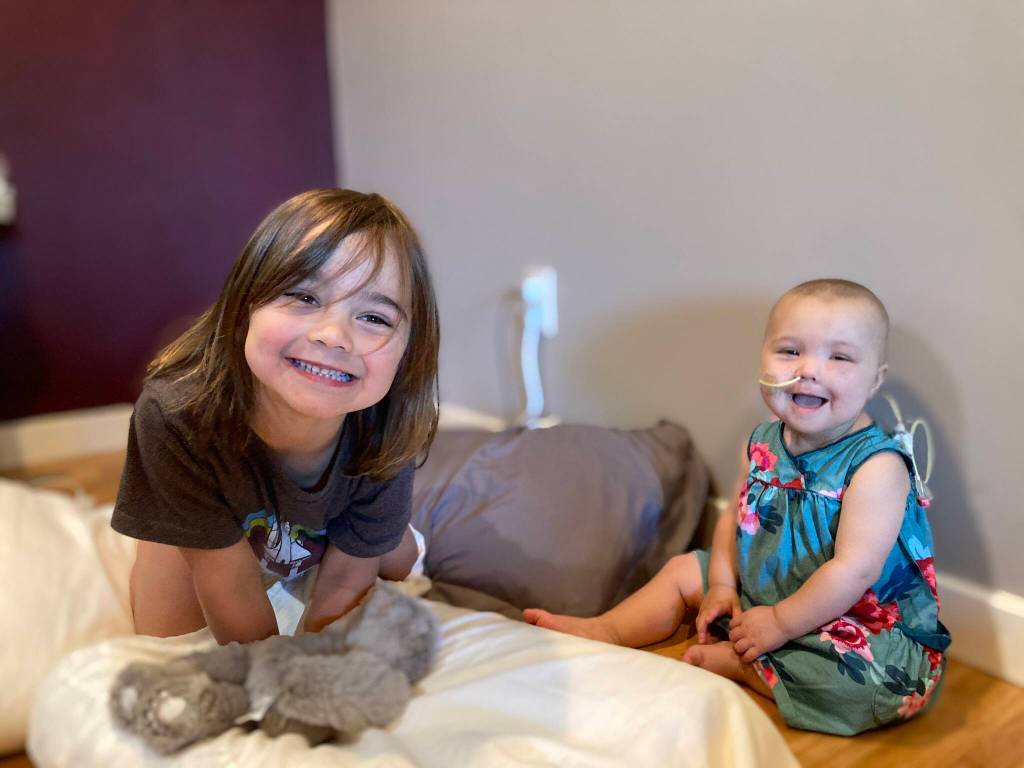 Amelia Bellmore, right, plays. with her older sister Lillian in 2021. (Courtesy photo / Be the Match)