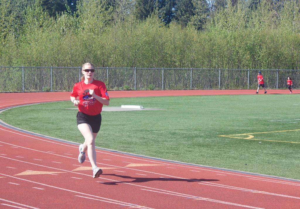 Leah Welch, 18, the daughter of an Alaska State Trooper, is first to cross the finish line during the Alaska Law Enforcement Torch Run on Saturday. (Mark Sabbatini / Juneau Empire)