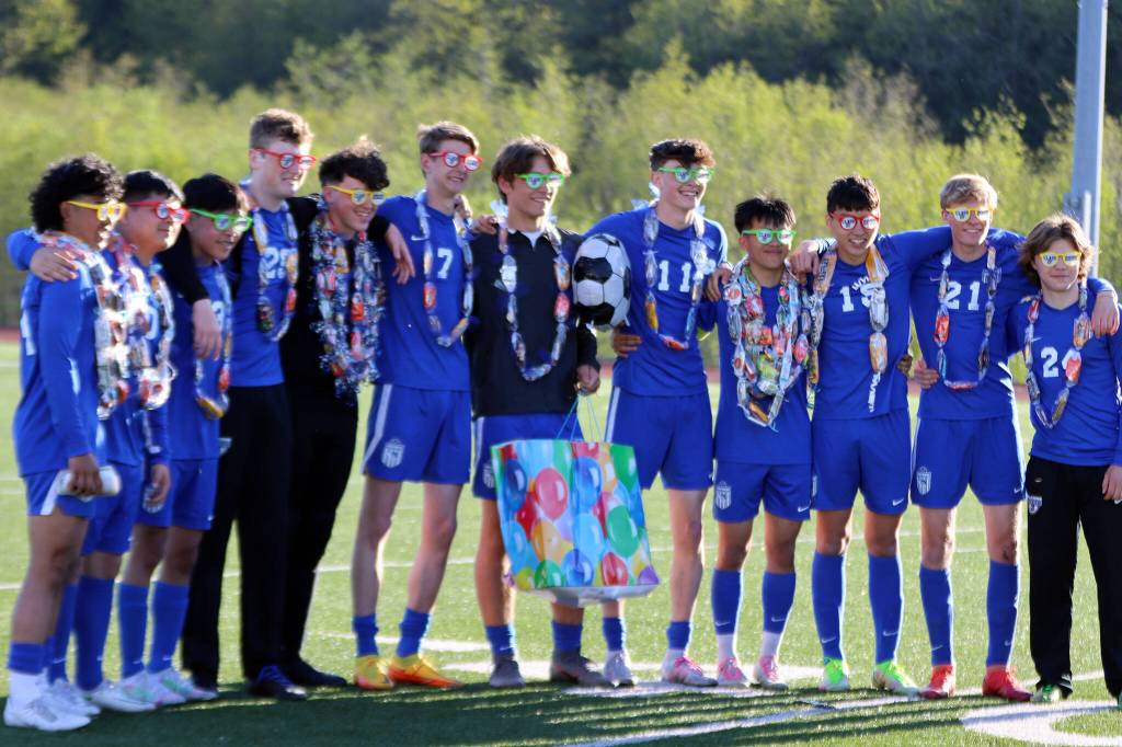 TMHS seniors don Class of 2022 glasses during a group photo ahead of Saturdays game. The seniors, Bryce Albay, Omar Alvarez, Miguel Romero, Jaden White, Miles Peterson, Darin Tingey, Wallace Adams, Talon Briggs, Phillip Lam, Ammon Kawakami, John Magalhaes, Cade Babcock and Seth Shannara (not pictured) will play their next game at state. (Ben Hohenstatt / Juneau Empire)