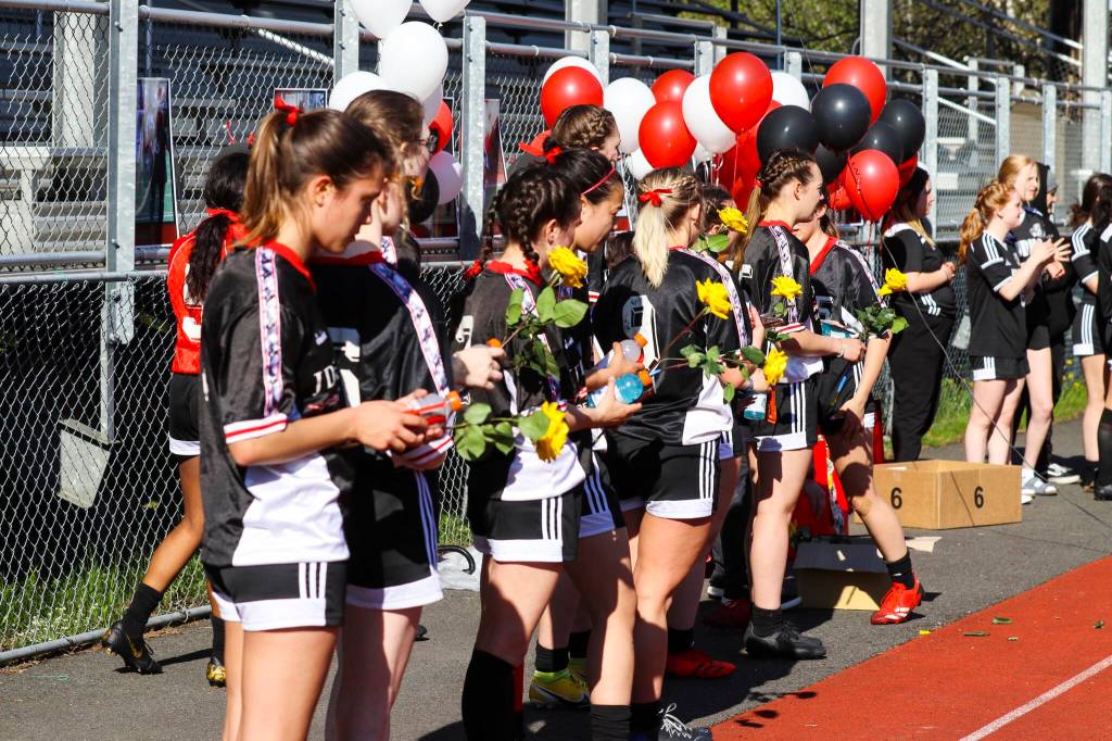 Underclass JDHS players prepare to hand flowers to seniors Blake Plummer, Brooke Sanford, Clara Don, Ella Goldstein, Kyla Bentz, Maile Quigley, Marina Lloyd, McKenna McNutt, Merry Newman, Natanya Reed, Sekoia Prince, Sierra Kanouse, Sophia Pugh and Zuri DeJean on senior night on May 19, 2022. Theyll play their final games as the #1 in the state championship. (Michael S. Lockett / Juneau Empire)