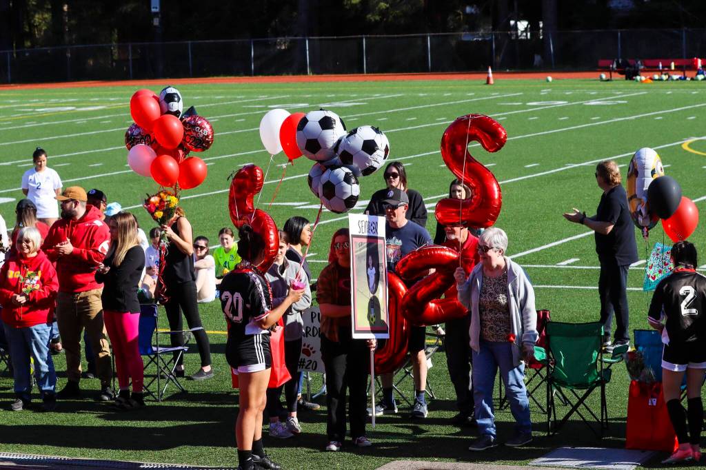 JDHS players and fans recognized seniors Blake Plummer, Brooke Sanford, Clara Don, Ella Goldstein, Kyla Bentz, Maile Quigley, Marina Lloyd, McKenna McNutt, Merry Newman, Natanya Reed, Sekoia Prince, Sierra Kanouse, Sophia Pugh and Zuri DeJean on May 22, 2022. Theyll play their final high school games together this week at the state tournament in Anchorage. (Michael S. Lockett / Juneau Empire)
